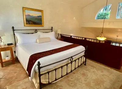 a bedroom with a large bed in a room at The Emerald Iguana Inn in Ojai
