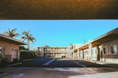 an empty parking lot in front of a building at Tropic Lodge in Anaheim