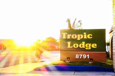 a sign for a tropic lodge on a street at Tropic Lodge in Anaheim