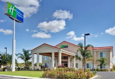 a hotel with a sign in front of a building at Holiday Inn Express Delano Highway 99 by IHG in Delano