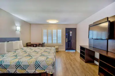a hotel room with a bed and a flat screen tv at Motel 6-Inglewood, CA in Inglewood