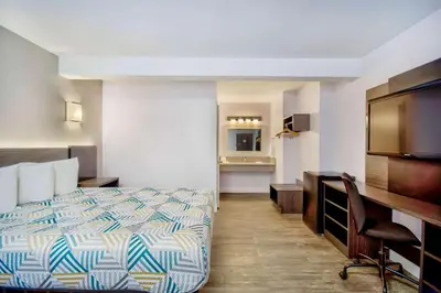 a hotel room with a bed and a desk at Motel 6-Inglewood, CA in Inglewood