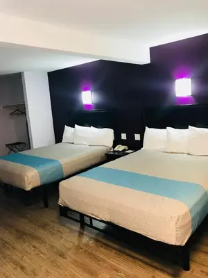 two beds in a hotel room with purple lights at Motel 6-Inglewood, CA in Inglewood
