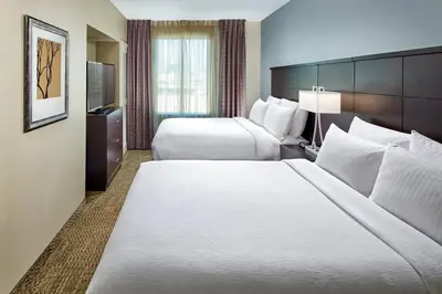 a hotel room with two beds and a television at Staybridge Suites Anaheim At The Park by IHG in Anaheim