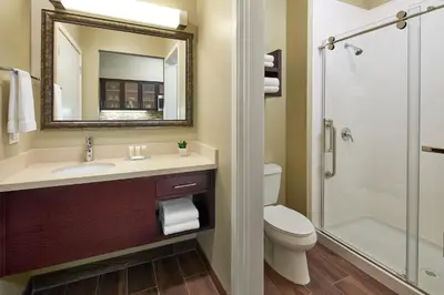 a bathroom with a toilet and a sink and a shower at Staybridge Suites Anaheim At The Park by IHG in Anaheim