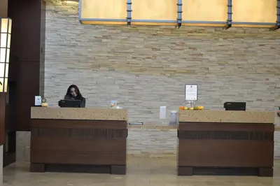 a woman sitting at a counter with a laptop at Embassy Suites Palmdale in Palmdale