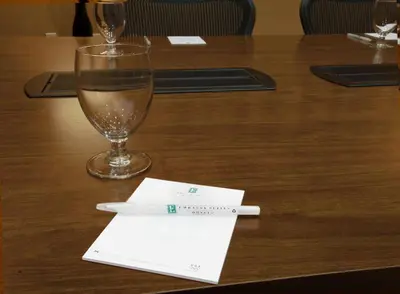 a glass of wine and a pen on a table at Embassy Suites Palmdale in Palmdale