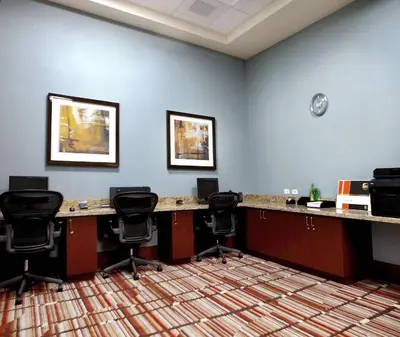 an office with desks and chairs in a room at Embassy Suites Palmdale in Palmdale