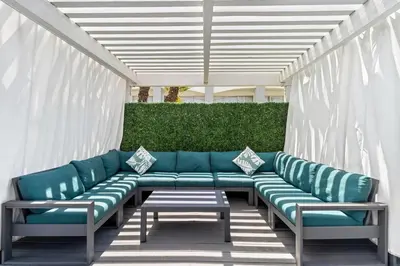 a row of green benches on a patio at Hourglass Hotel, Trademark Collection by Wyndham in Bakersfield