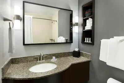 a bathroom with a sink and a mirror at Courtyard by Marriott Los Angeles Woodland Hills in Woodland Hills