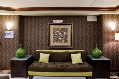 a living room with a couch and two vases at Holiday Inn Express & Suites Woodland Hills by IHG in Woodland Hills