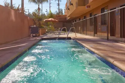 a swimming pool with a slide in a building at Holiday Inn Express & Suites Woodland Hills by IHG in Woodland Hills