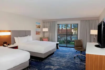 a hotel room with two beds and a television at DoubleTree by Hilton Bakersfield in Bakersfield