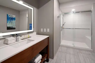 a bathroom with a white sink and a shower at DoubleTree by Hilton Bakersfield in Bakersfield