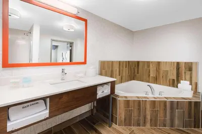 a bathroom with a tub and a sink and a mirror at Hampton Inn & Suites Thousand Oaks in Thousand Oaks