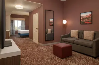 a living room with a couch and a bed at Hilton Garden Inn Fontana in Fontana