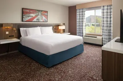 a large bed in a hotel room with a window at Hilton Garden Inn Fontana in Fontana