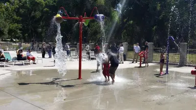 a group of children playing in a fountain in a park at Soledad Canyon Cottage 5 in Ravenna