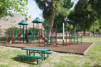 a park with a playground with a slide and benches at Soledad Canyon Wheelchair Accessible Cottage 16 in Ravenna