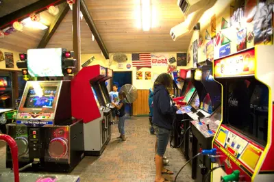 two people playing video games in a arcade at Soledad Canyon Wheelchair Accessible Cottage 16 in Ravenna