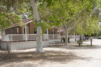 a building with trees in front of it at Soledad Canyon Studio Cabin 21 in Ravenna