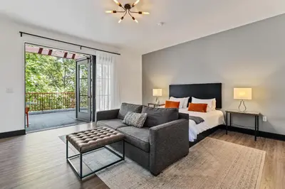 a living room with a couch and a bed at Hotel Casa 425 + Lounge, A Four Sisters Inn in Claremont
