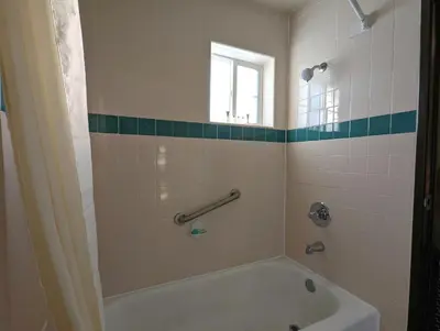 a bathroom with a bath tub and a window at Americas Best Value Inn Oxnard-Port Hueneme in Port Hueneme
