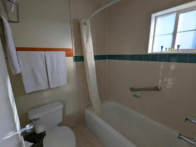 a bathroom with a tub and a toilet and a sink at Americas Best Value Inn Oxnard-Port Hueneme in Port Hueneme