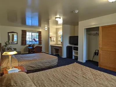 a hotel room with two beds and a television at Americas Best Value Inn Oxnard-Port Hueneme in Port Hueneme