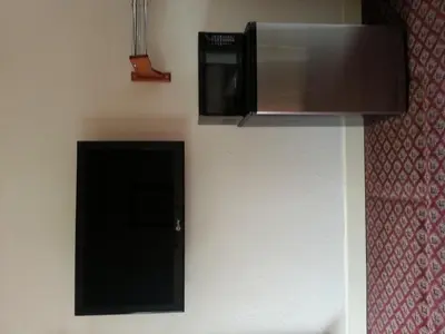 a kitchen with a microwave and a stove top oven at Walls Motel Long Beach in Long Beach