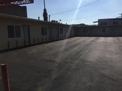 an empty parking lot in front of a building at Park Motel in Los Angeles