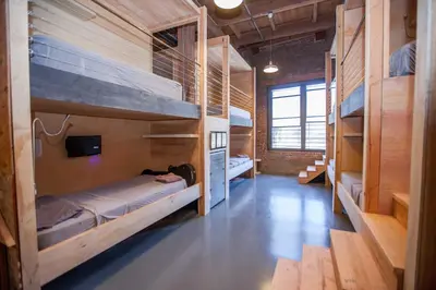 a room with two bunk beds and a television at PodShare DTLA in Los Angeles
