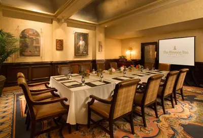 a conference room with a long table and chairs at The Mission Inn Hotel and Spa in Riverside