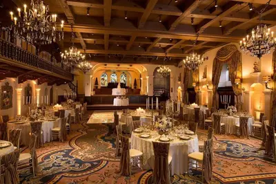 a banquet hall with tables and chairs and chandeliers at The Mission Inn Hotel and Spa in Riverside