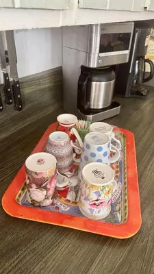 a tray with cups and saucers on a table at Dresden B & B in Los Angeles