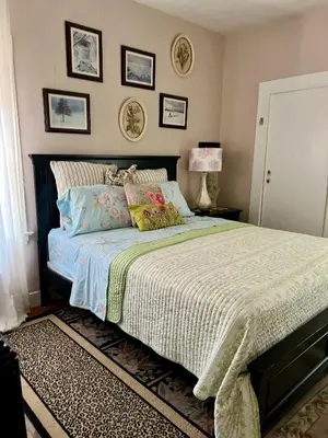 a bedroom with a large bed with pillows on it at Dresden B & B in Los Angeles