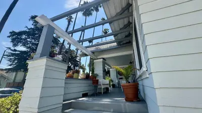 a porch of a house with potted plants on it at Dresden B & B in Los Angeles