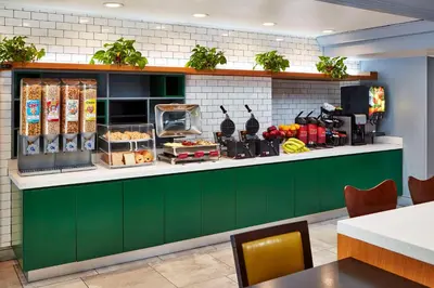 a restaurant with a green counter with food on it at Best Western Plus Meridian Inn & Suites, Anaheim-Orange in Orange