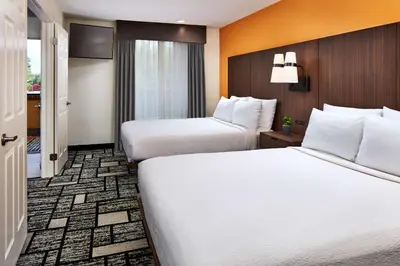 a hotel room with two beds with white sheets at Best Western Plus Meridian Inn & Suites, Anaheim-Orange in Orange