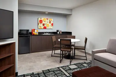 a kitchen with a table and chairs in a room at Best Western Plus Meridian Inn & Suites, Anaheim-Orange in Orange