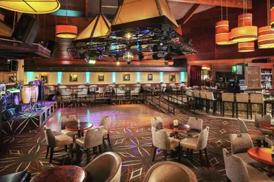 a restaurant with tables and chairs and a dance floor at DoubleTree by Hilton Ontario Airport in Ontario