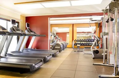 a gym with treadmills and machines in a room at DoubleTree by Hilton Ontario Airport in Ontario