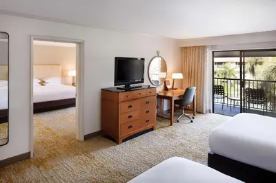 a hotel room with a bed and a desk with a television at DoubleTree by Hilton Ontario Airport in Ontario