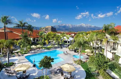 an aerial view of a resort pool with mountains in the background at DoubleTree by Hilton Ontario Airport in Ontario