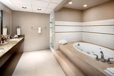 a large bathroom with a tub and a shower at DoubleTree by Hilton Ontario Airport in Ontario