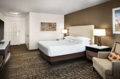 a hotel room with a bed and a chair at DoubleTree by Hilton Ontario Airport in Ontario