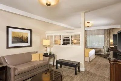 a living room with a couch and a bed at Ayres Suites Ontario at the Mills Mall - Rancho Cucamonga in Ontario