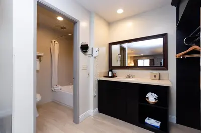 a bathroom with a sink and a mirror at Super 8 by Wyndham Anaheim/Disneyland Drive in Anaheim