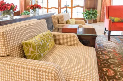 a living room with two couches and a table at Ayres Hotel Anaheim in Anaheim