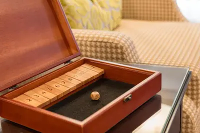 a wooden box with a dice in it on a table at Ayres Hotel Anaheim in Anaheim